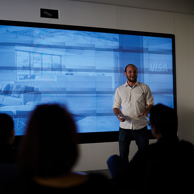 Man standing in front of an audience.