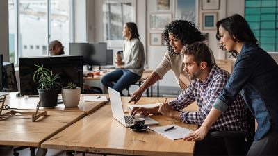 Workers looking at a laptop