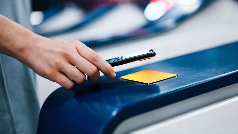 consumer-using-contactless-payment-at-terminal-with-phone-800x450