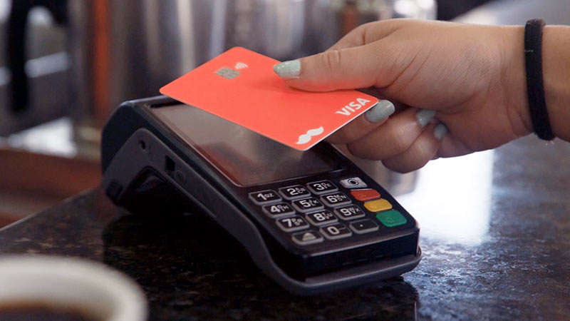 Person using Rappi card at point-of-sale.