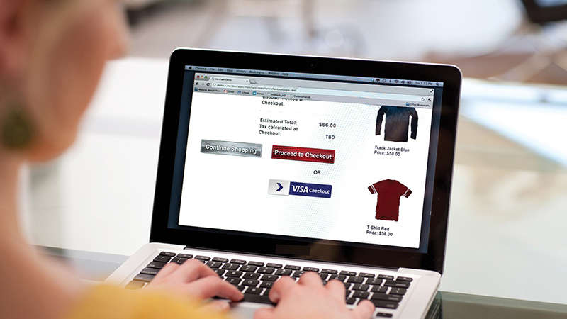 A woman with a laptop doing some online shopping on a website that has Visa Checkout. A woman with a laptop doing some online shopping on a website that has Visa Checkout.