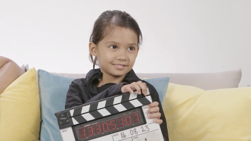 child holding film clapperboard