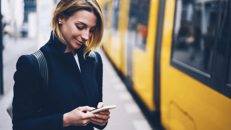 woman on phone at train station