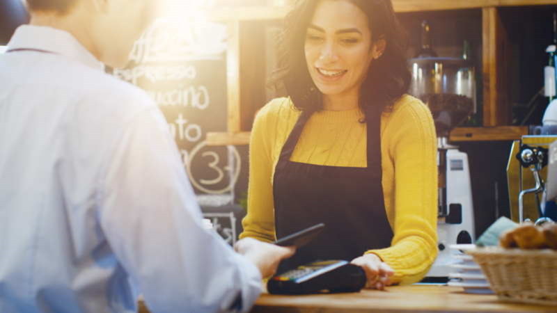 Man paying by card in coffee shop