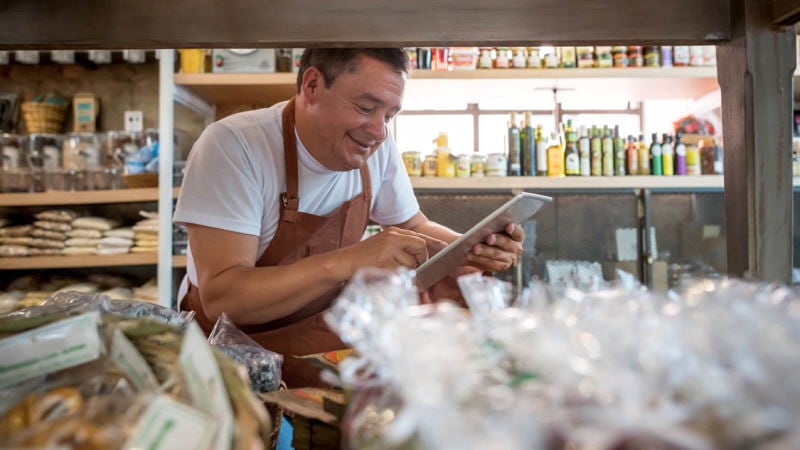 Shopkeeper using tablet