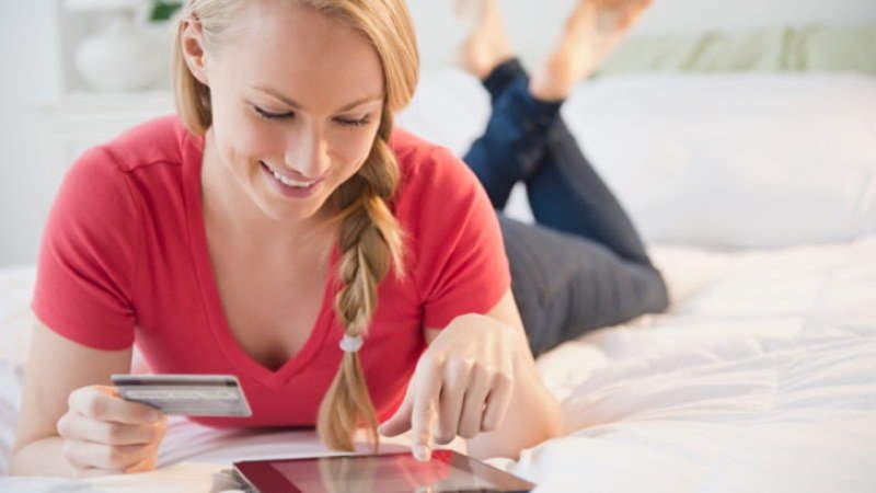 Woman paying via tablet