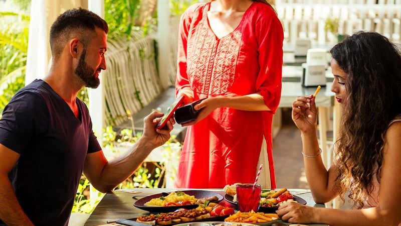 couple paying for meal in restaurant